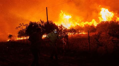 Greek authorities say the bodies of 18 people have been found in area struck by a major wildfire